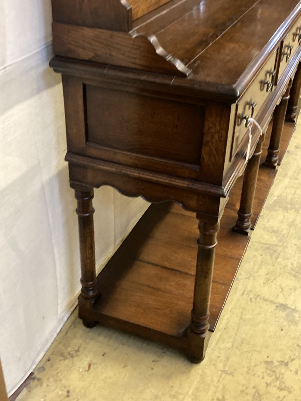 An 18th century style oak dresser, width 182cm depth 45cm height 198cm